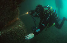 Chris McTernan diving under Swanage Pier. Image by Jeremy Cuff