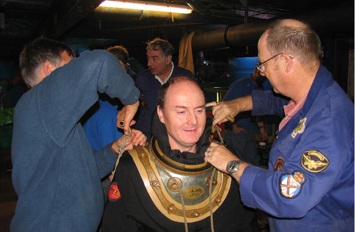 Chris McTernan dressing up in 'standard' diving gear at the London Aquarium with the HDS